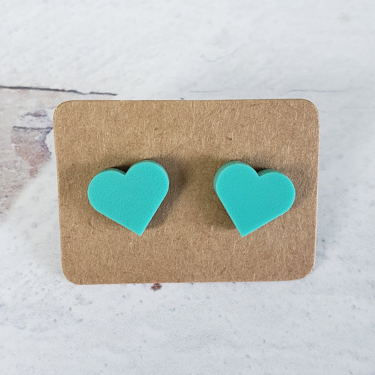 Matte mint green heart shaped stud earrings.
