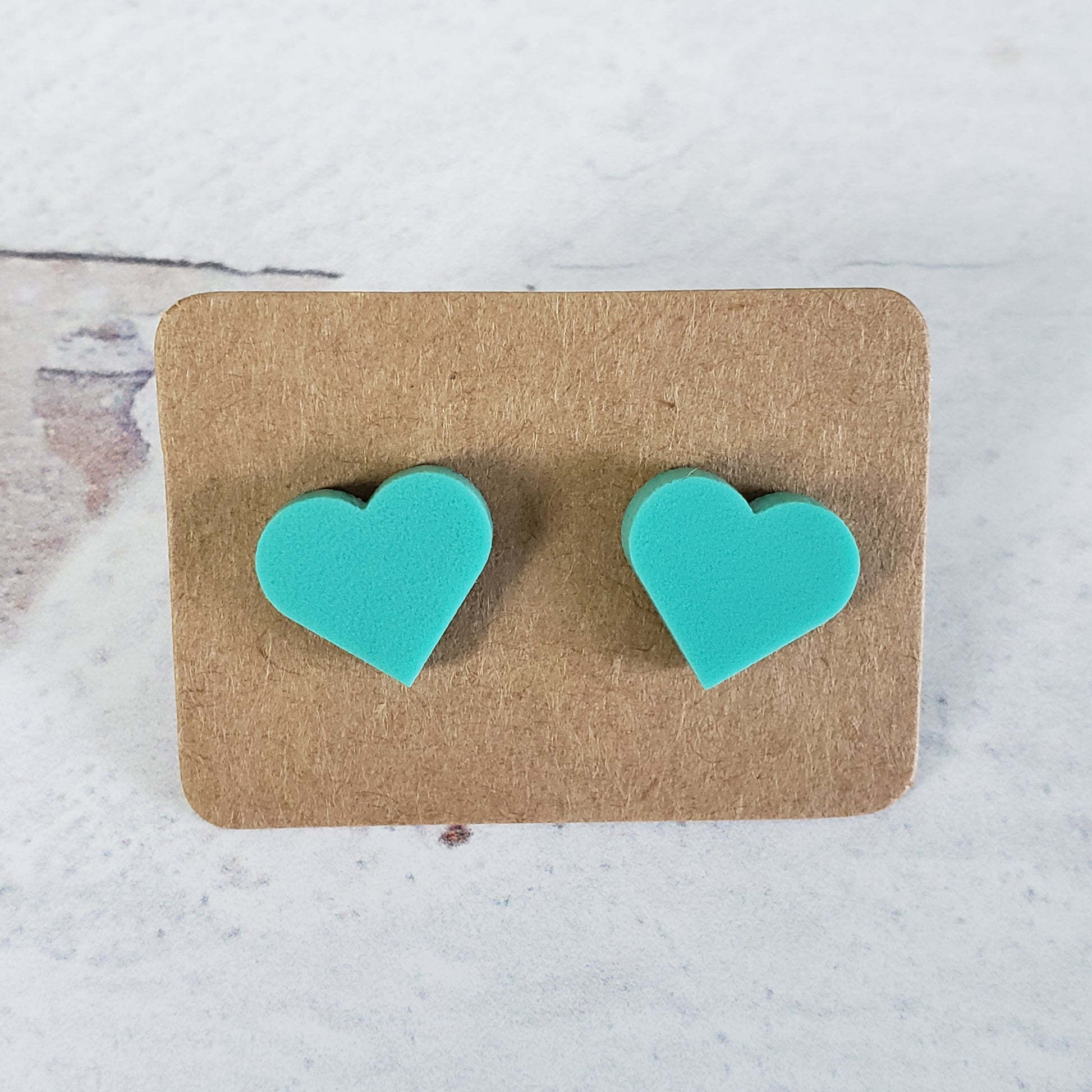 Matte mint green heart shaped stud earrings.