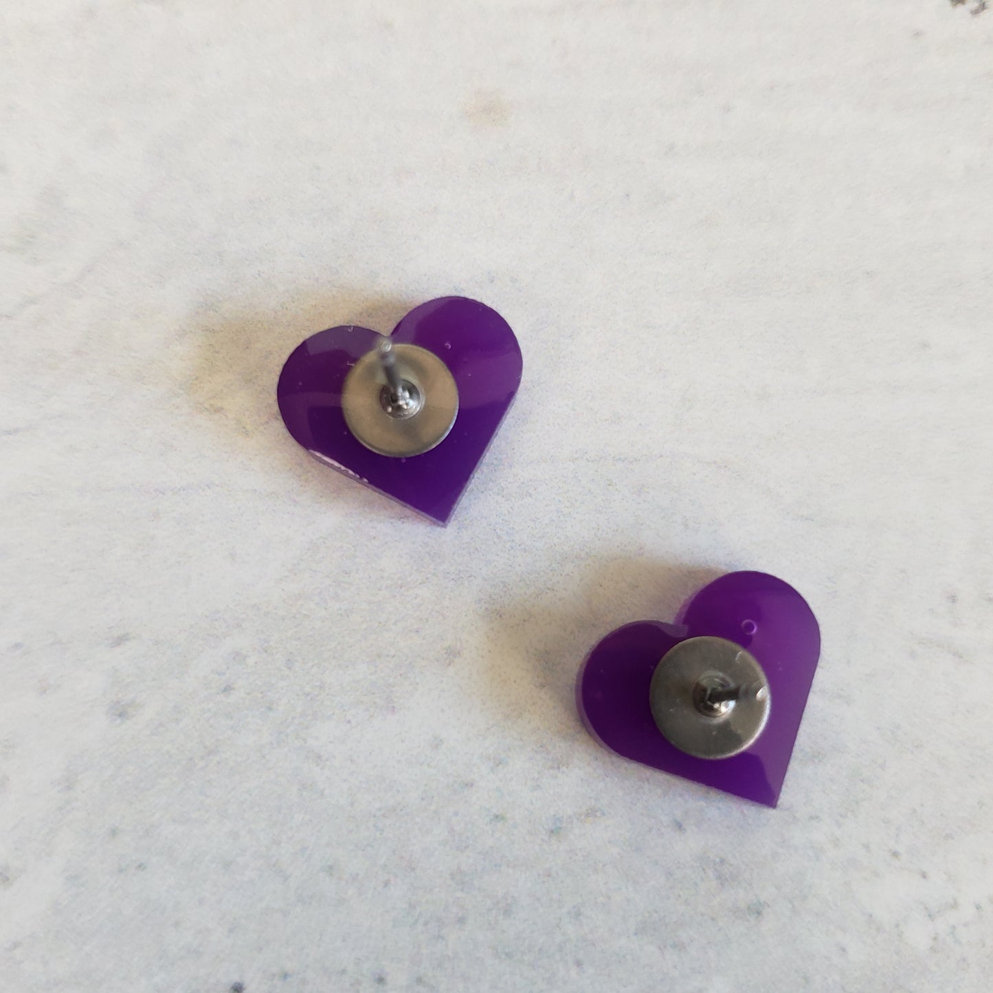 backside of gloss purple heart shaped stud earrings