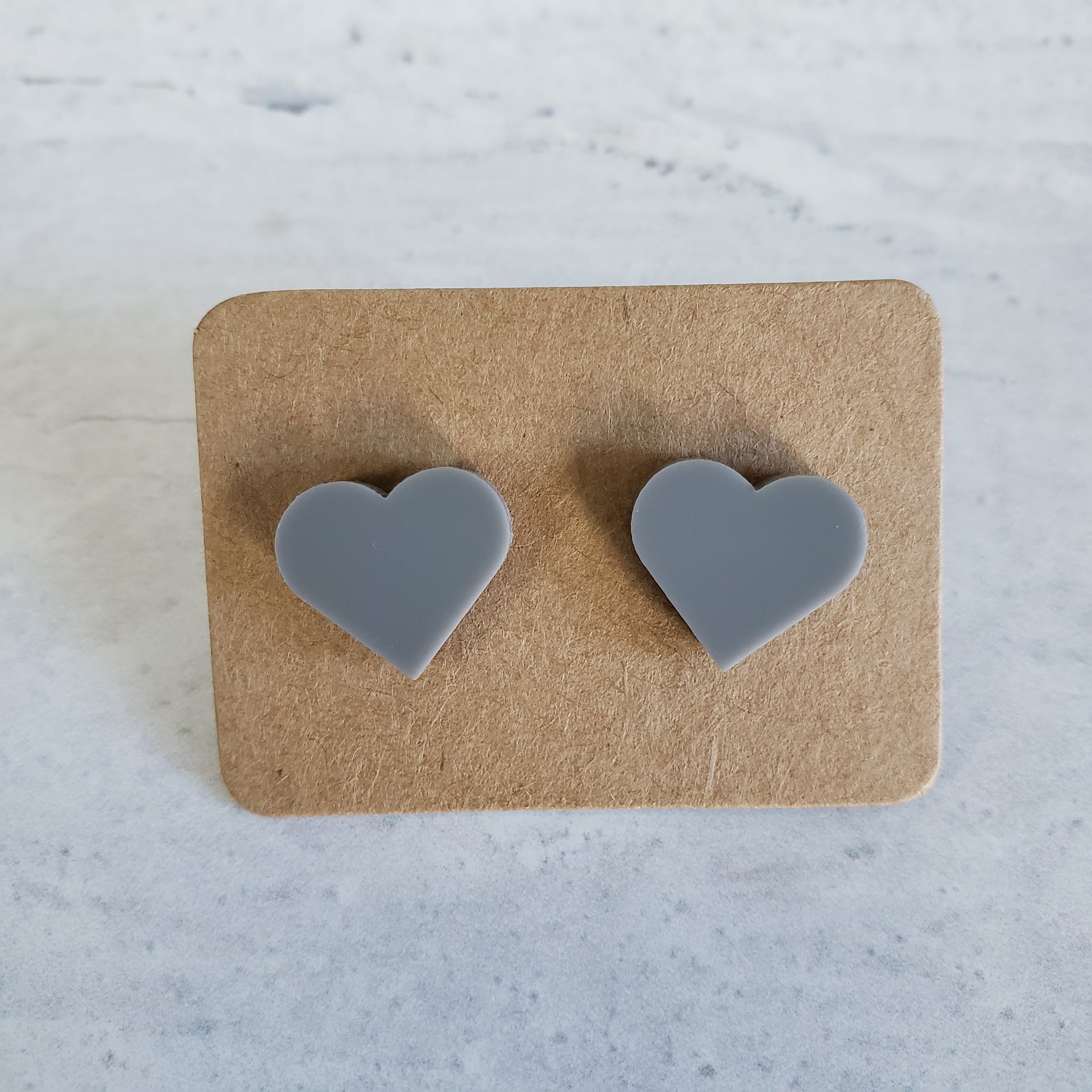 Gloss gray heart shaped stud earrings.