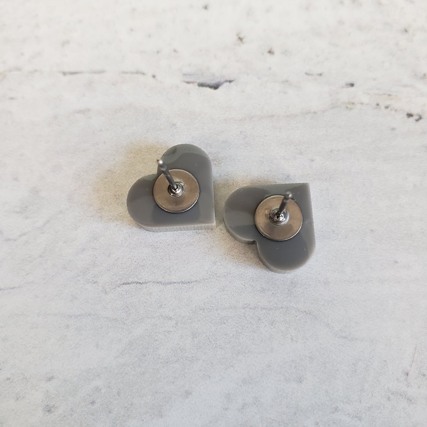 backside of gloss gray heart shaped stud earrings