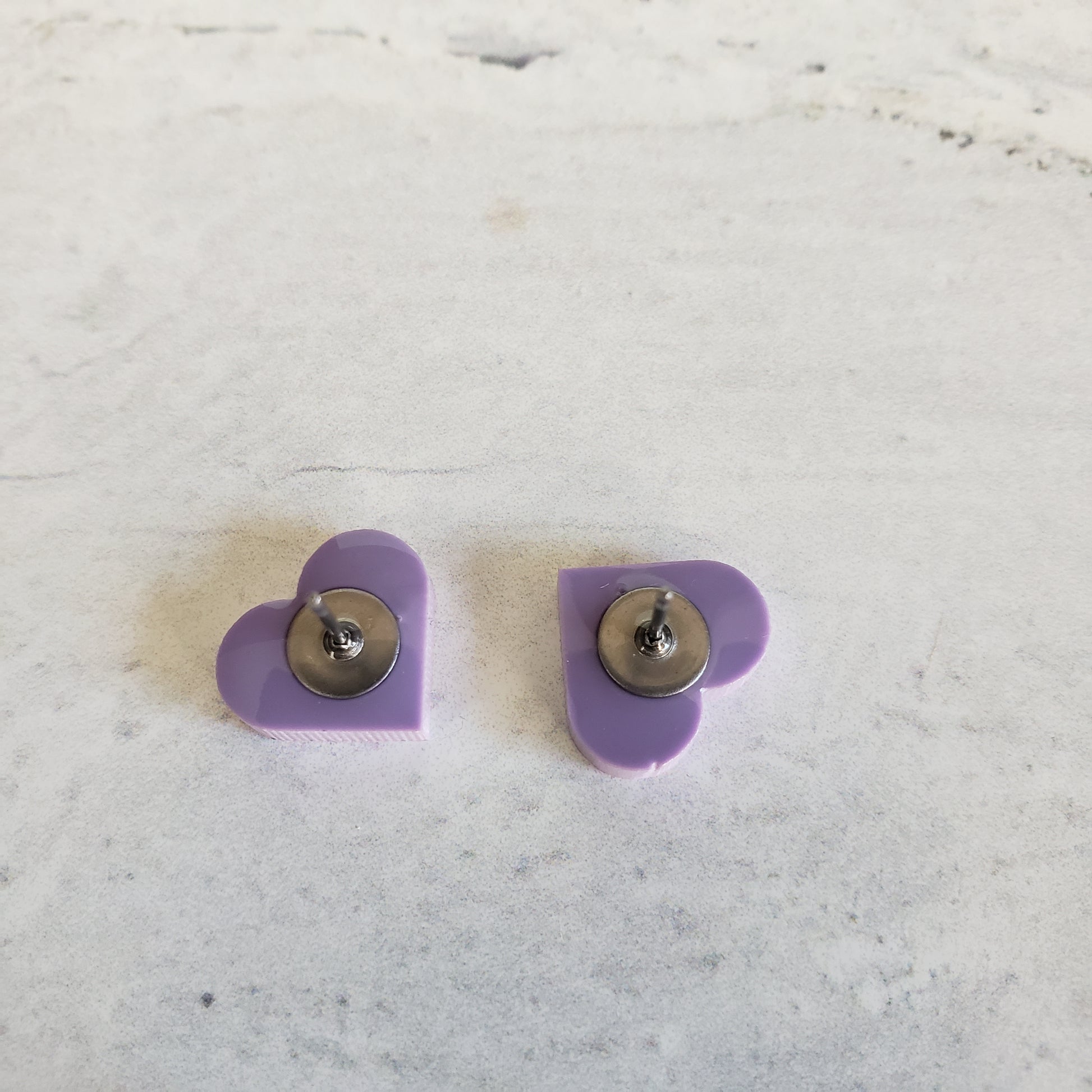 backside of matte purple pastel heart shaped stud earrings