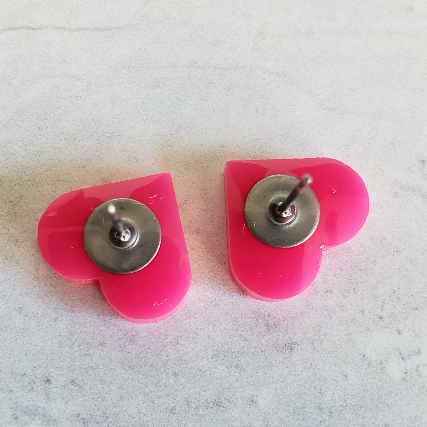backside of gloss hot pink heart shaped stud earrings