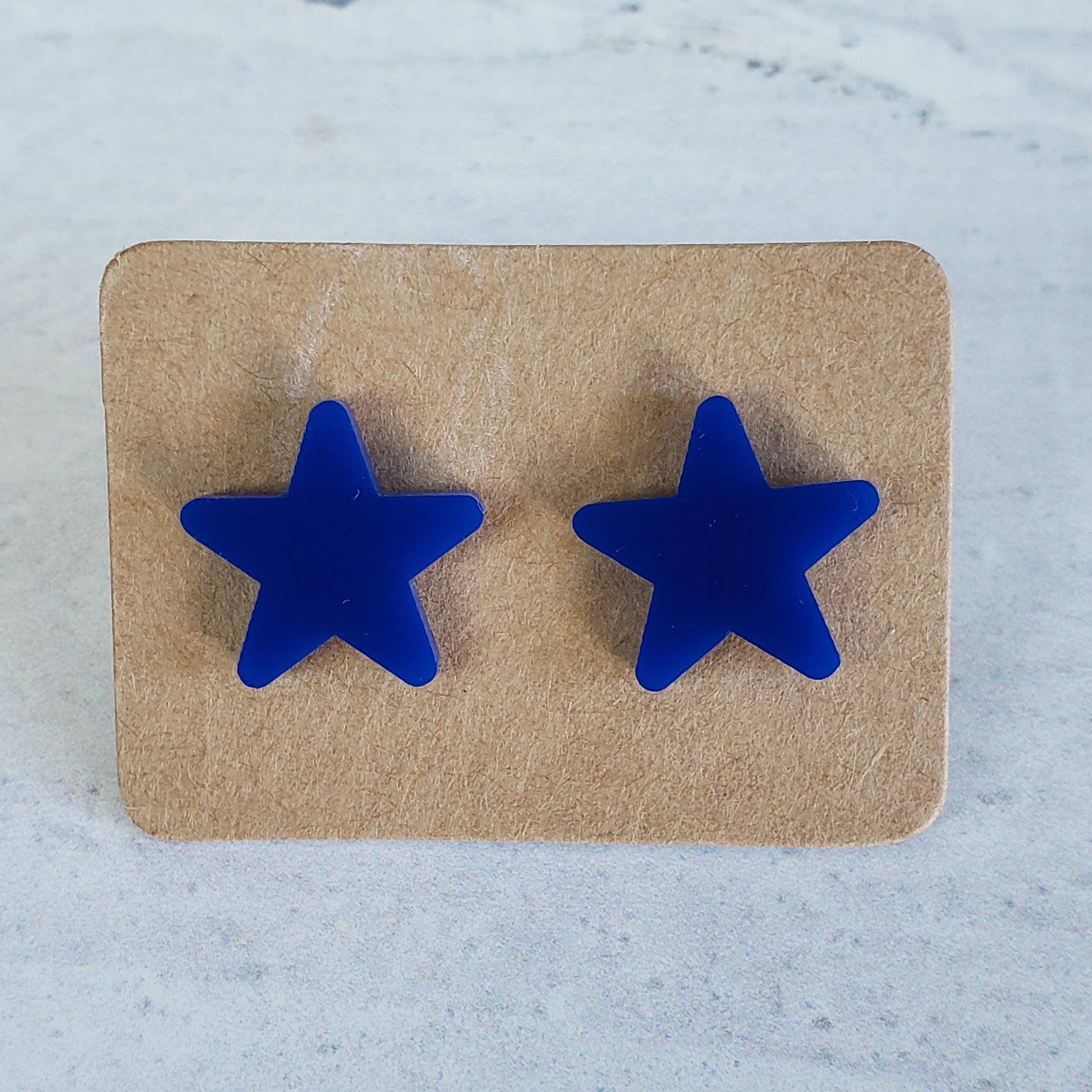 Navy blue star stud earrings on earring cards