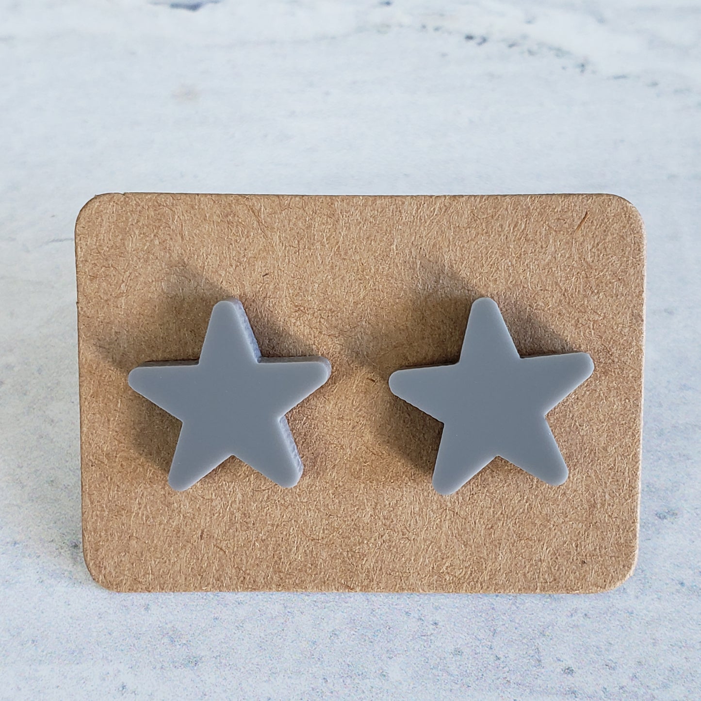 Gray star stud earrings on earring cards
