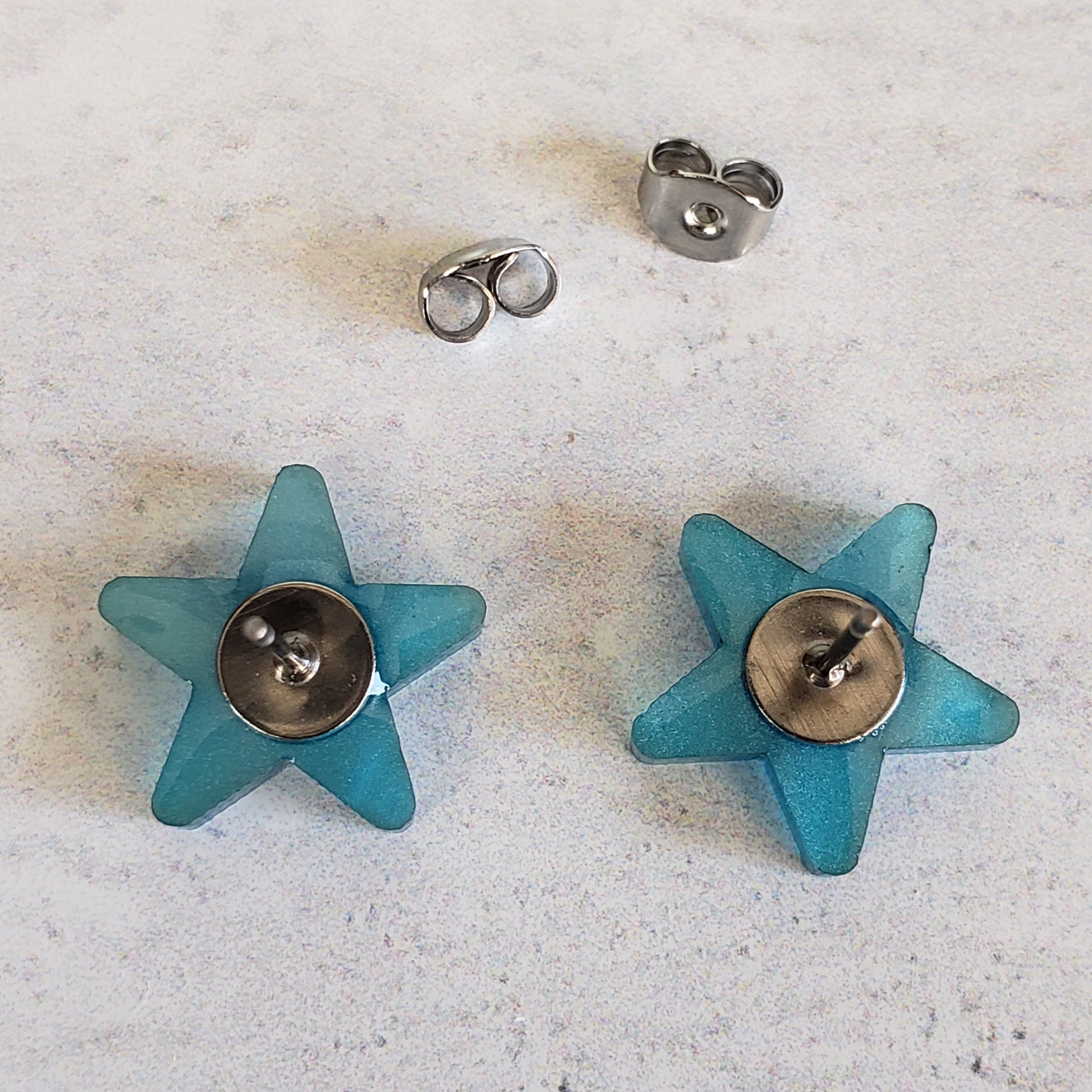 Backside of blue pearl star earrings to show post