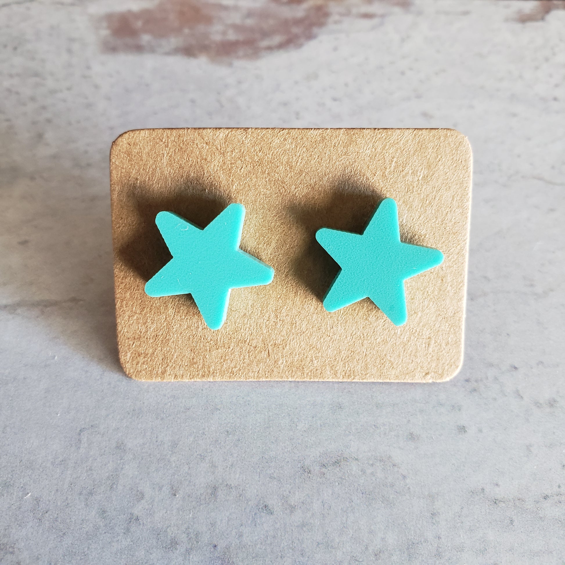 Matte mint green star stud earrings on earring cards