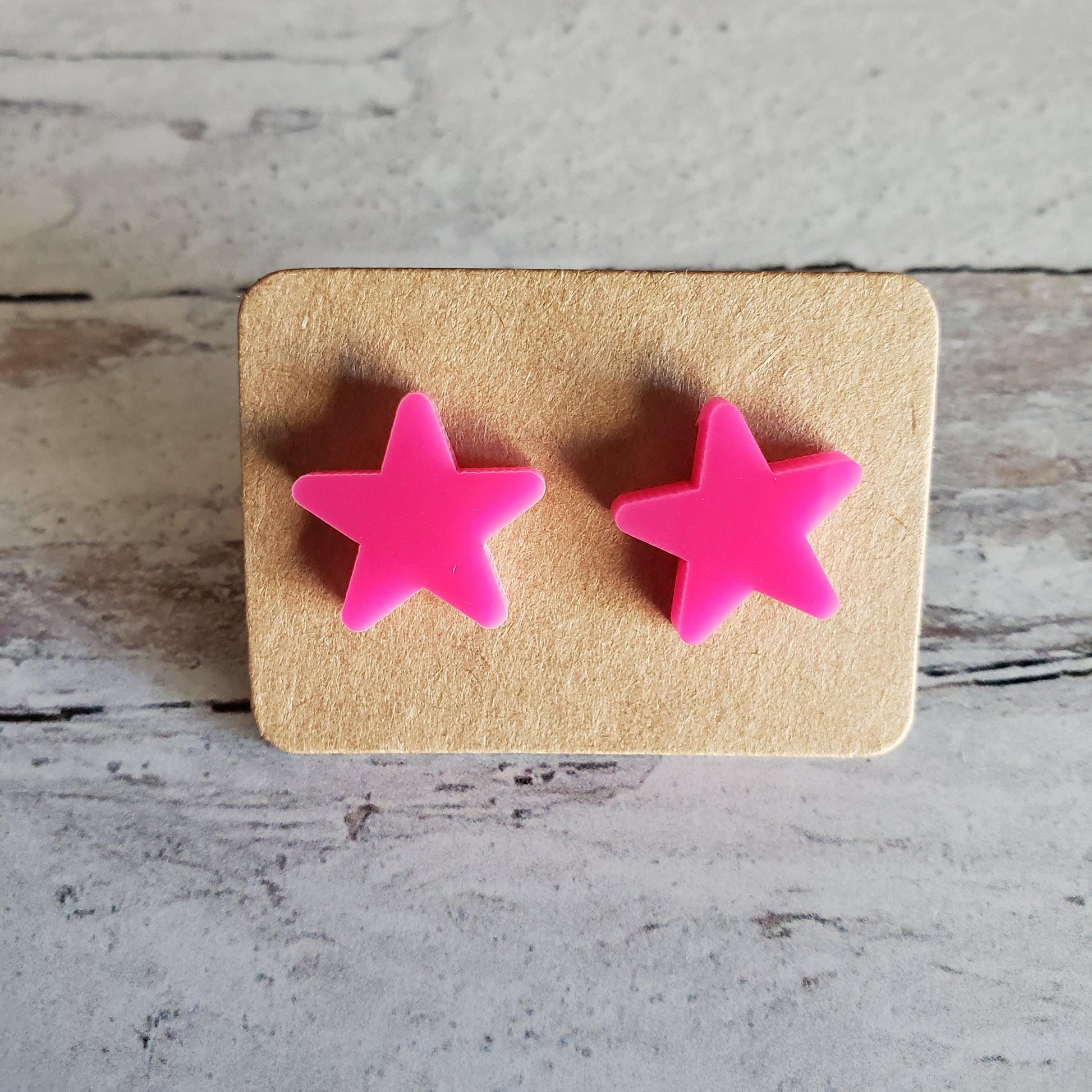 Hot pink star stud earrings on earring card
