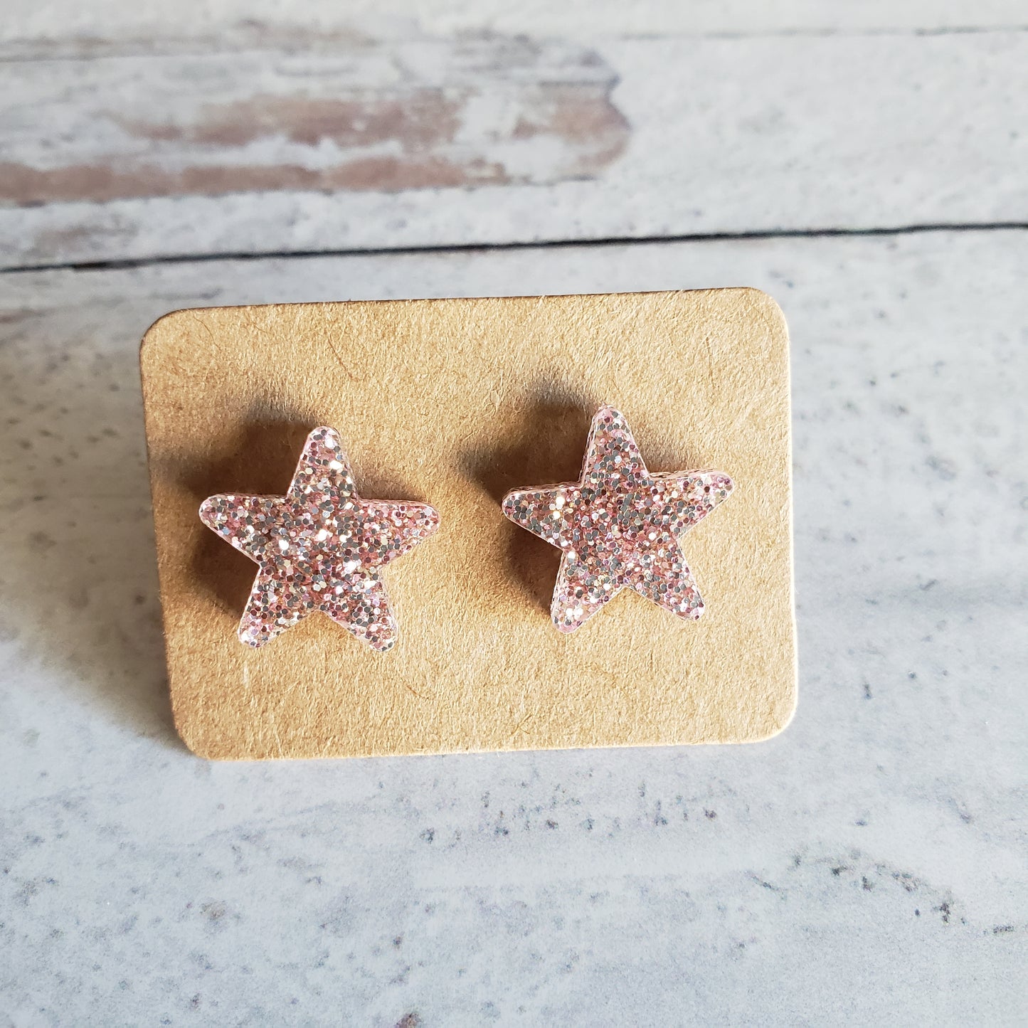 Rose gold tone glitter star stud earrings on earring cards
