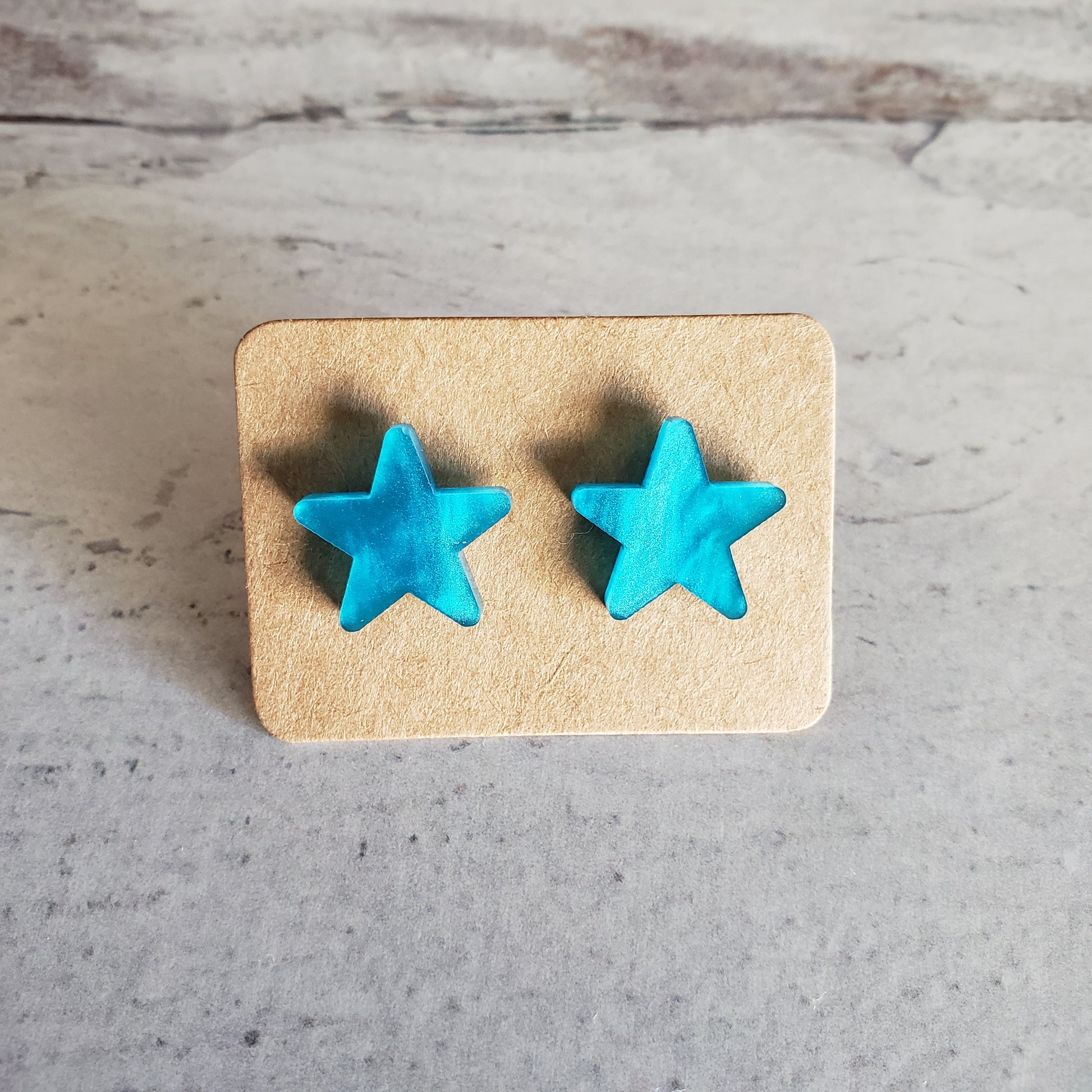 Blue pearl star shaped stud earrings on earring card