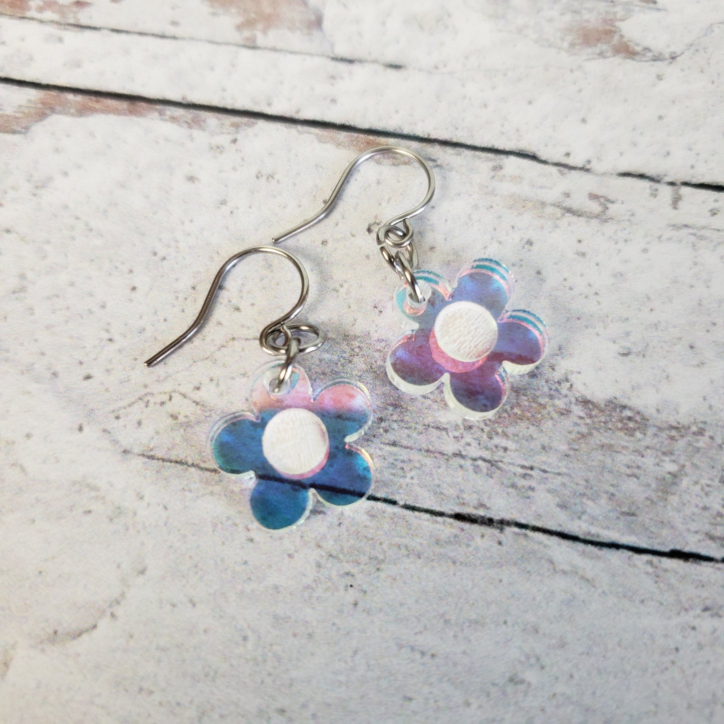 Small rainbow iridescent daisy flowers on small stainless steel ear wires.