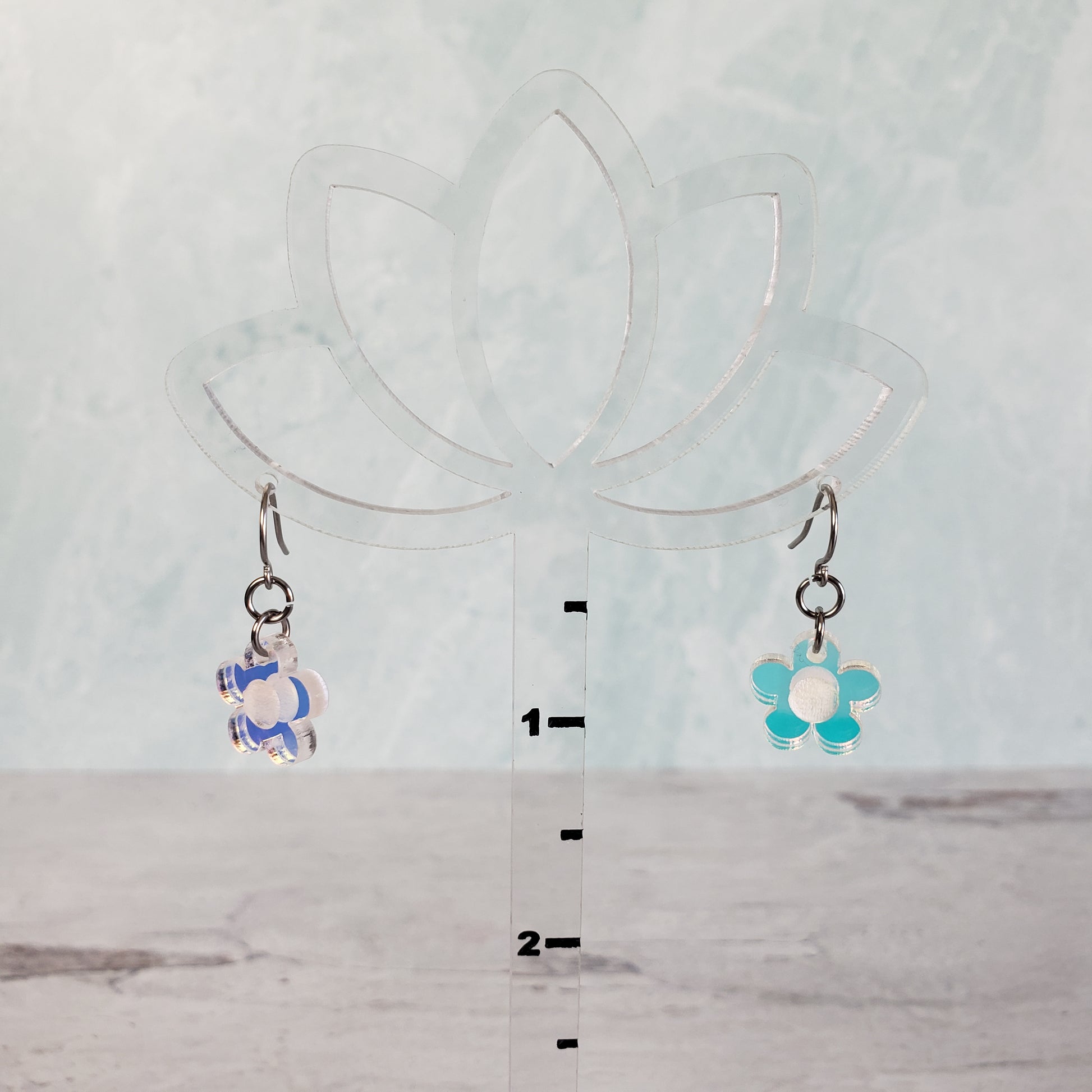 Small daisy earrings on hanging display