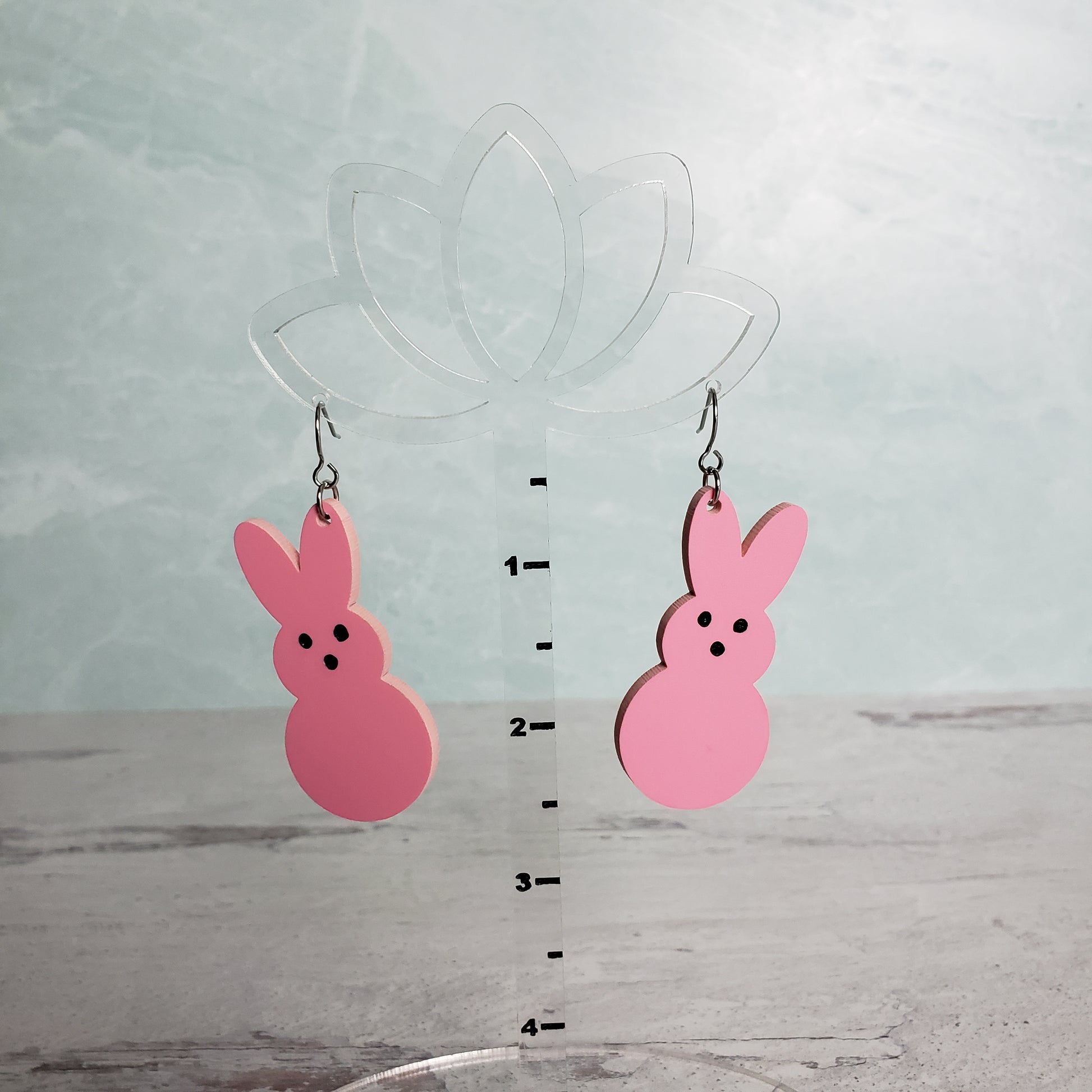 Matte Pink Marshmallow Bunny Earrings on stainless earring wires. on hanging display for size.