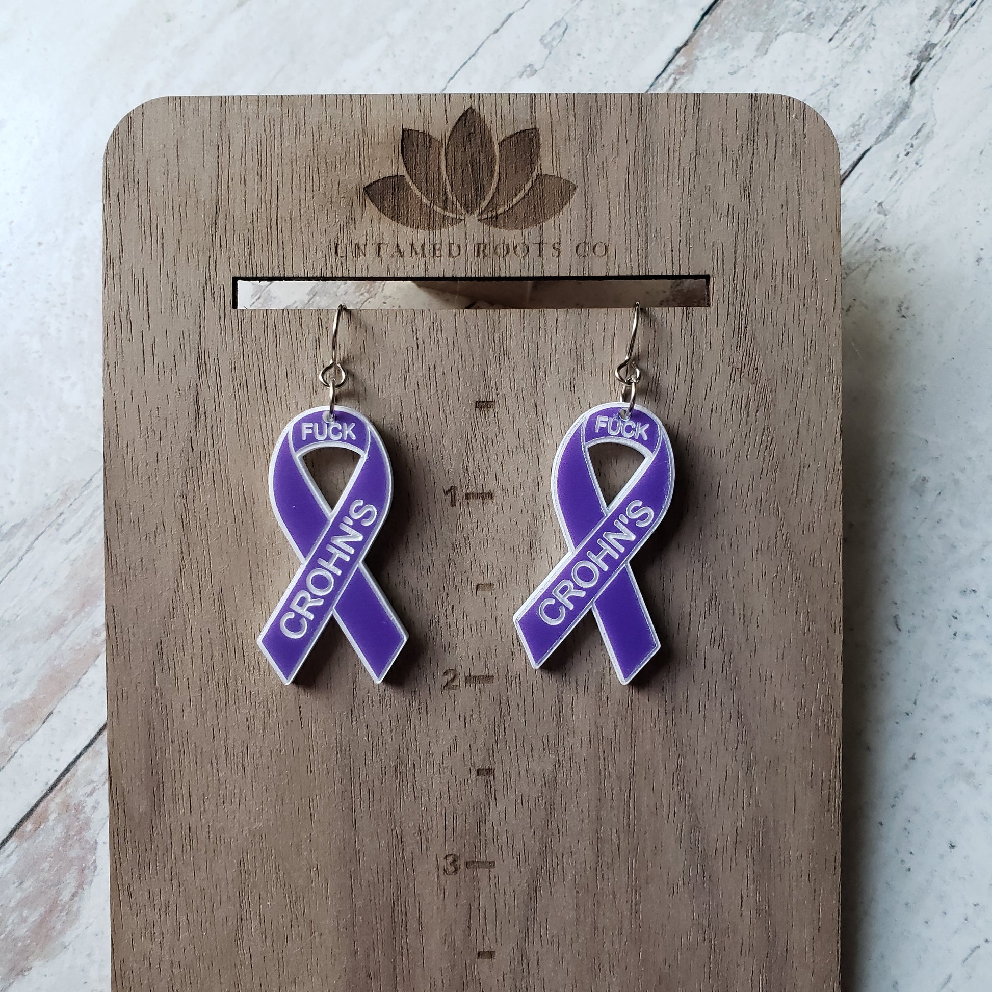 Pair of purple awareness ribbons, with engraving. Stainless steel earring wires. Size reference.
