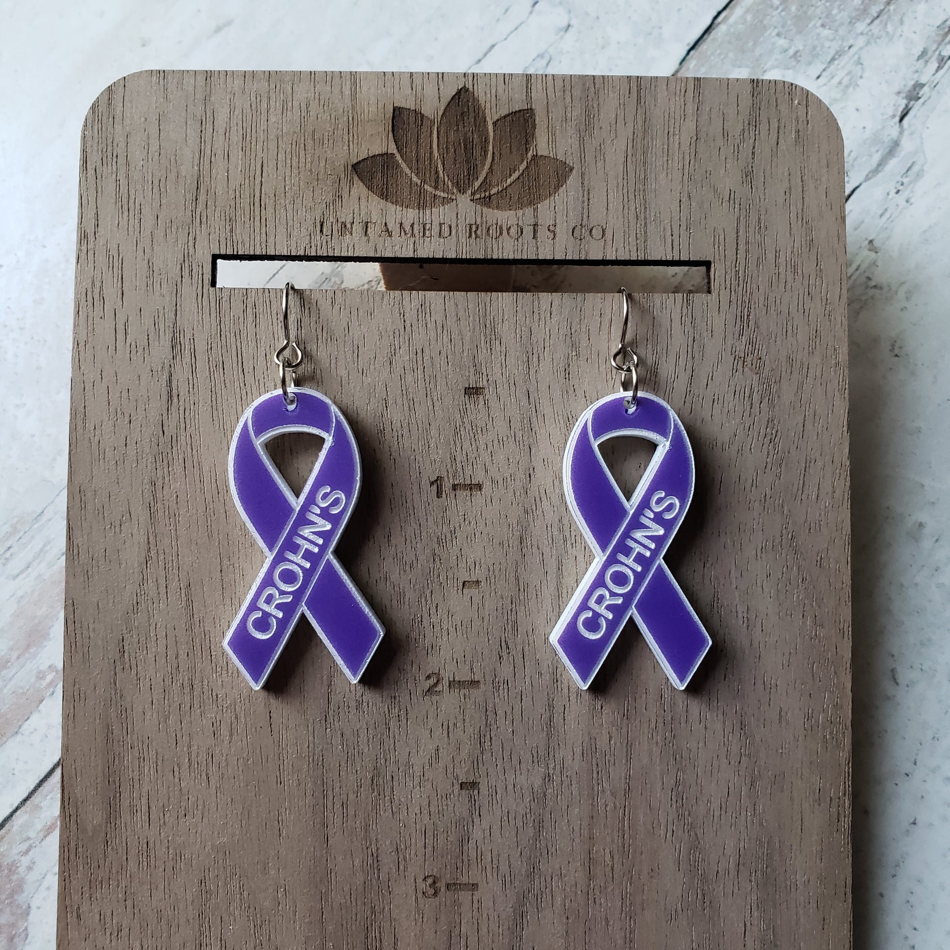 Pair of purple awareness ribbons, with engraving. Stainless steel earring wires. Size reference.