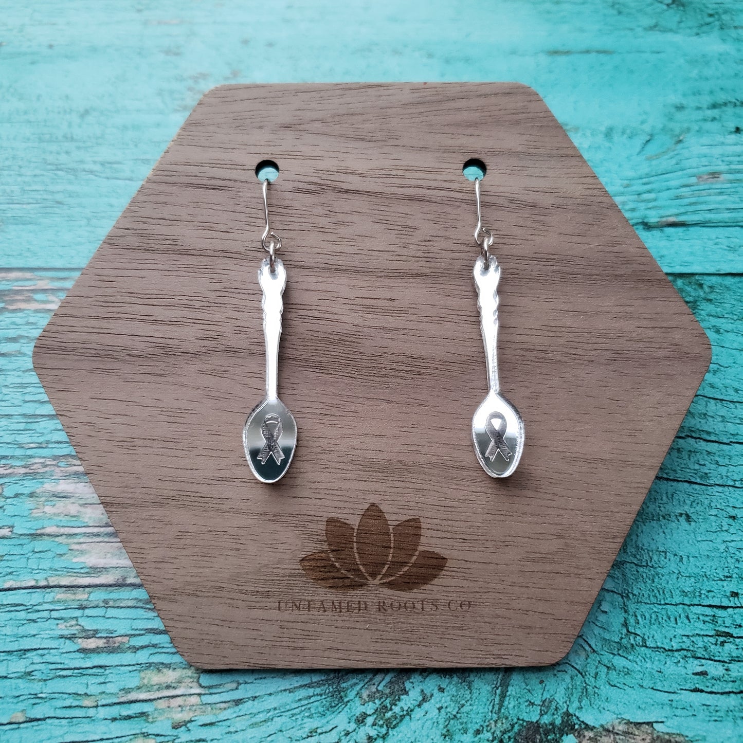 Silver mirror acrylic spoon shaped dangle earrings with small ribbon engraving.  On stainless steel earring wires.