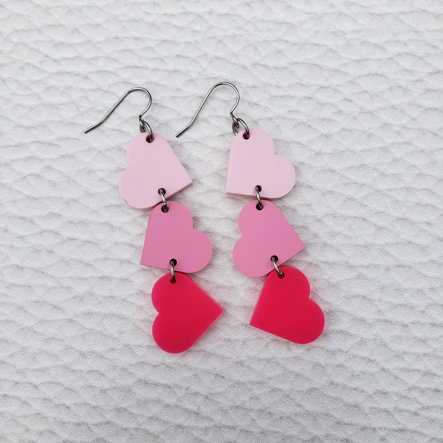 Matte Pink Tumbling Heart Earrings on Stainless Steel