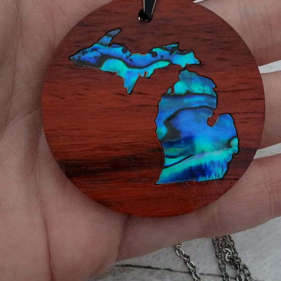 Michigan State shape in abalone inlayed into African Padauk wood.