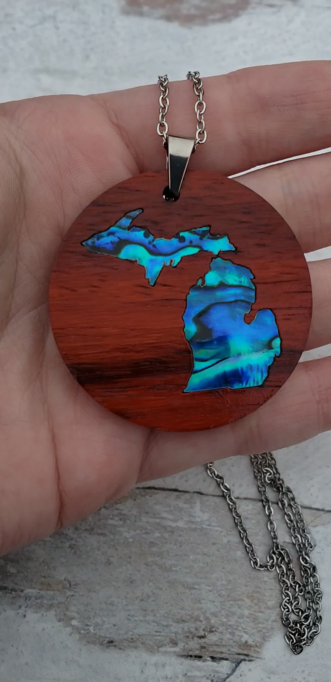 Michigan State shape in abalone inlayed into African Padauk wood.