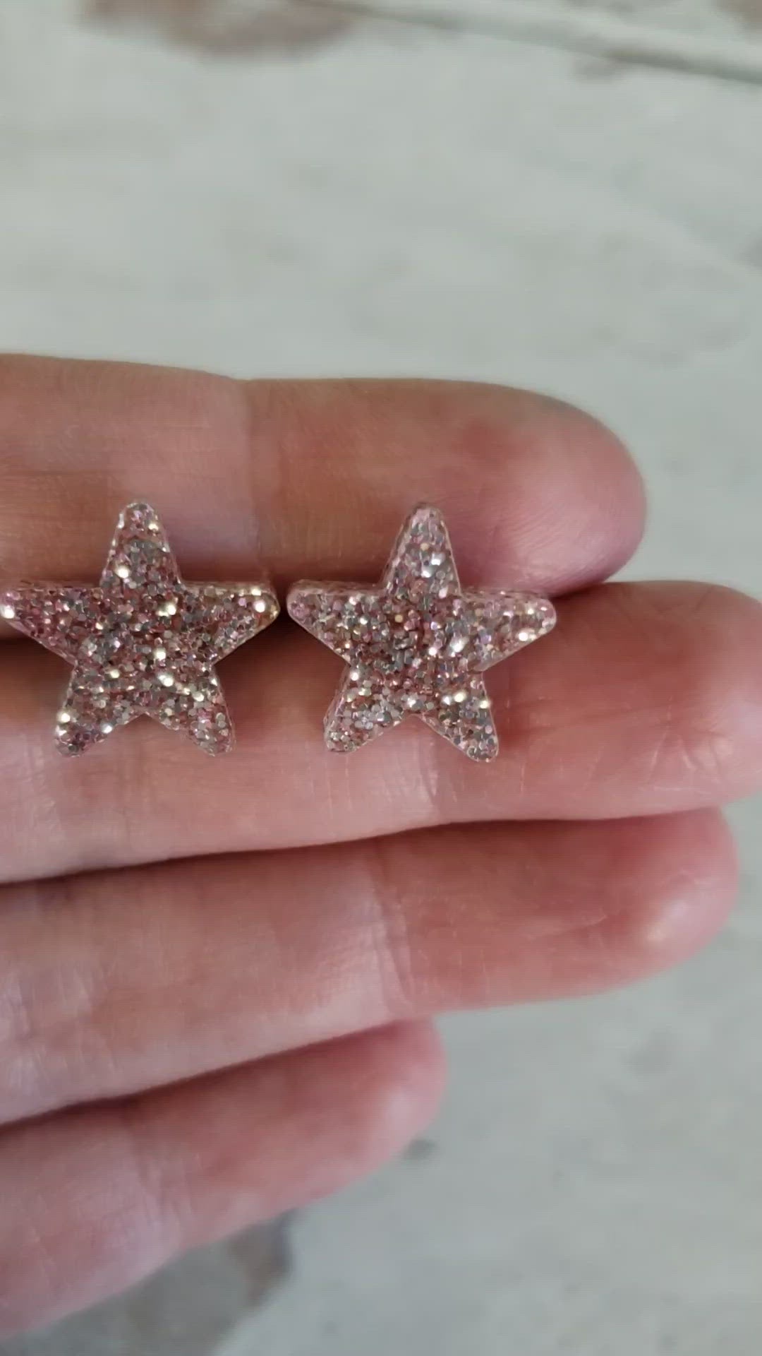 Video of rose gold tone glitter star shaped earrings to show glitter effect