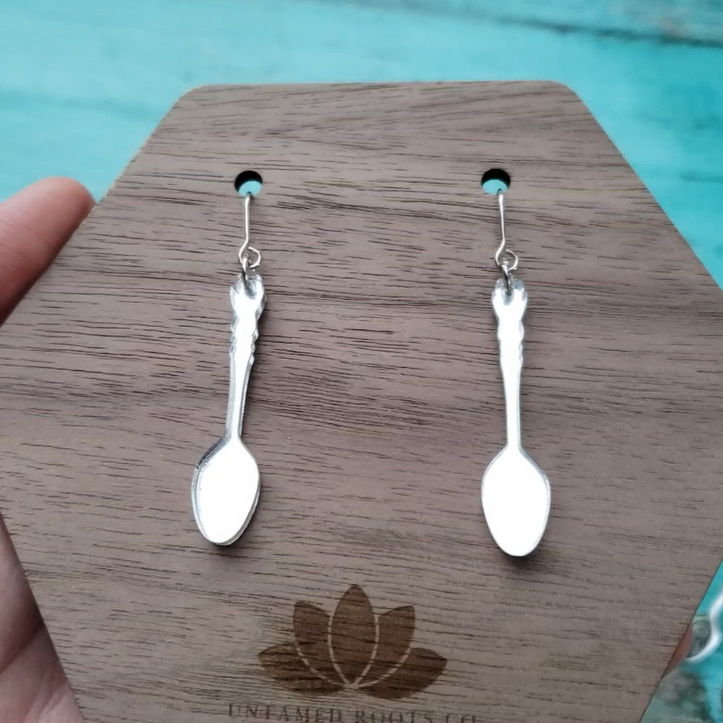 Video of silver mirror acrylic spoon shaped dangle earrings to show the mirrored effect.  Part of the spoon theory